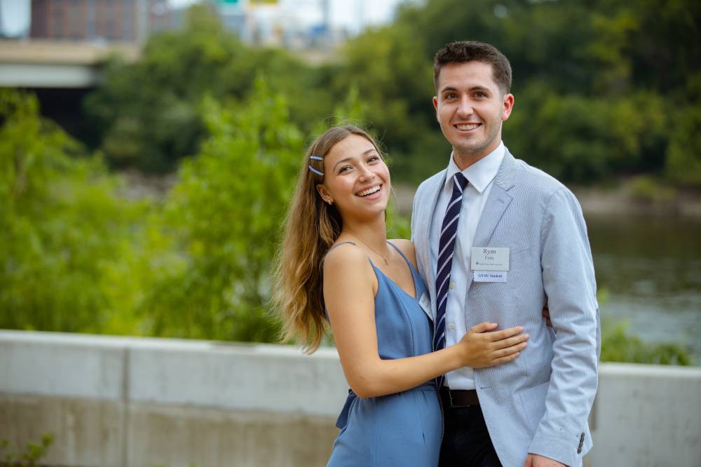 A couple posing for a photo outside.
